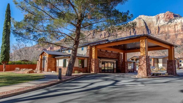 Nestled amidst the breathtaking mountain landscape and just steps from Zion National Park, the Best Western Plus Zion Canyon Inn & Suites offers the perfect blend of comfort and convenience for your Zion National Park lodging experience. Located within walking distance of the park entrance, local dining, and shopping, this hotel is ideal for travelers looking to immerse themselves in the beauty of Zion National Park without the hassle of long commutes. Enjoy easy access to the free Zion shuttle service, available from March through November, right at the hotel’s entrance. This Zion hotel boasts serene views from private balconies, allowing guests to unwind and take in the awe-inspiring surroundings. Set back from the main road, it offers a peaceful escape perfect for those seeking a tranquil yet centrally located retreat. Whether you’re planning a day of adventure or a leisurely visit, the Best Western Plus Zion Canyon Inn & Suites provides an unmatched blend of convenience, comfort, and stunning scenery that will enhance your Zion National Park experience.